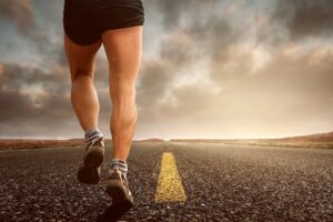 Be an Elite Athlete - man running down a highway.